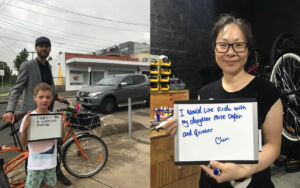 Moreland Bicycle User members holding a small whiteboard where they have written that they would like safer biking streets
