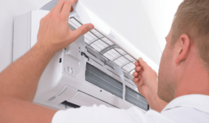 Person checking air-conditioner