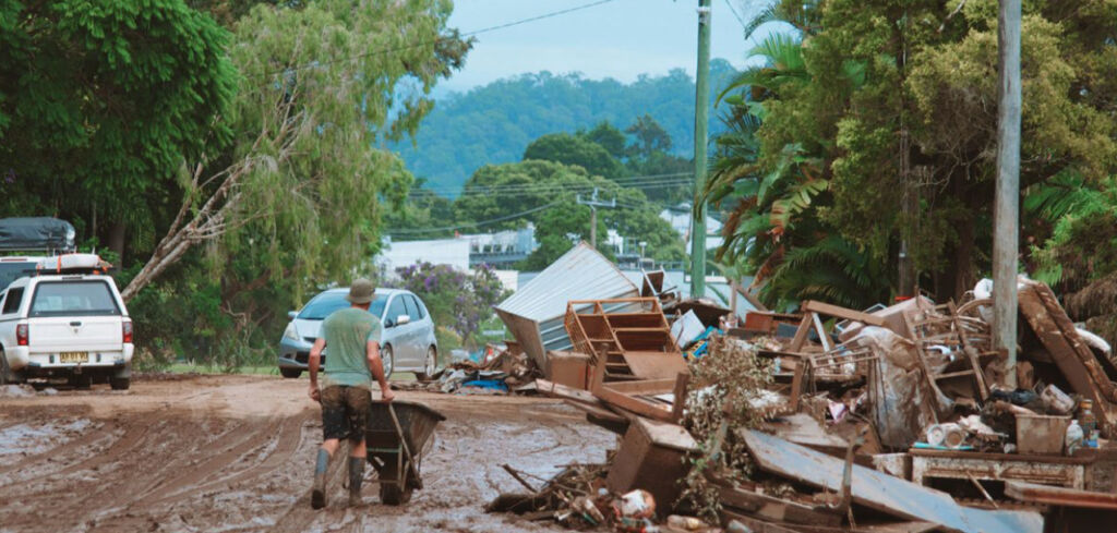 Man cleans up after flooded home