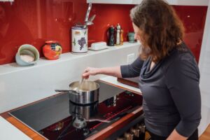 Women cooking on induction cooktop