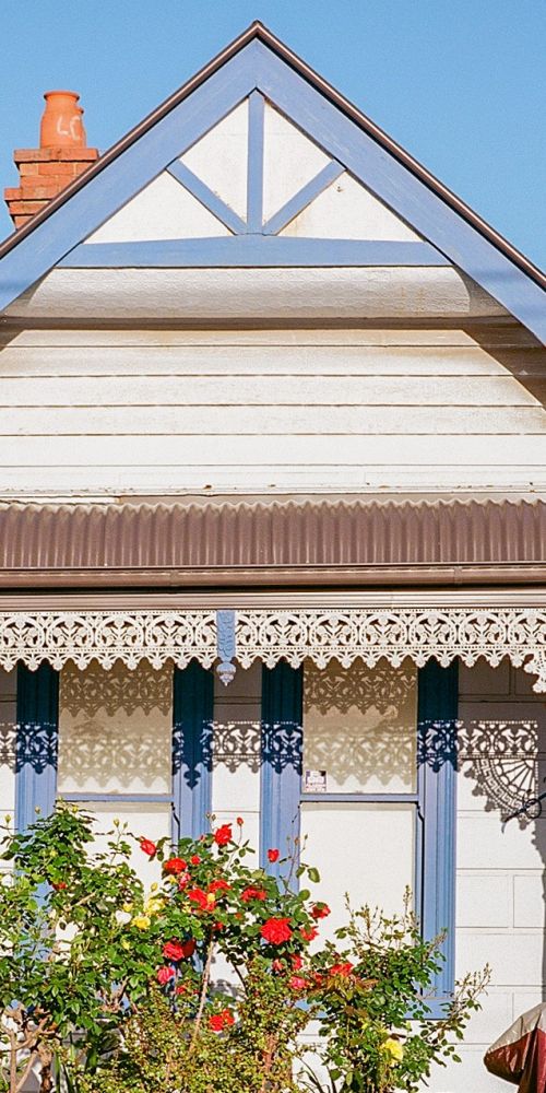 A small weatherboard terrace house in an inner city street.