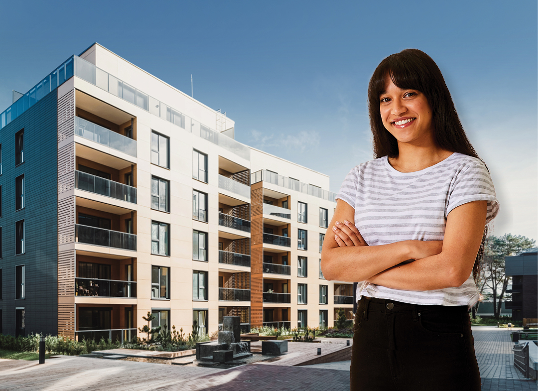 Women standing in front of apartment block.