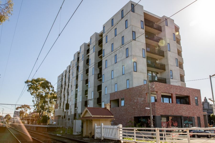 Nine-story apartment block alongside a railway crossing