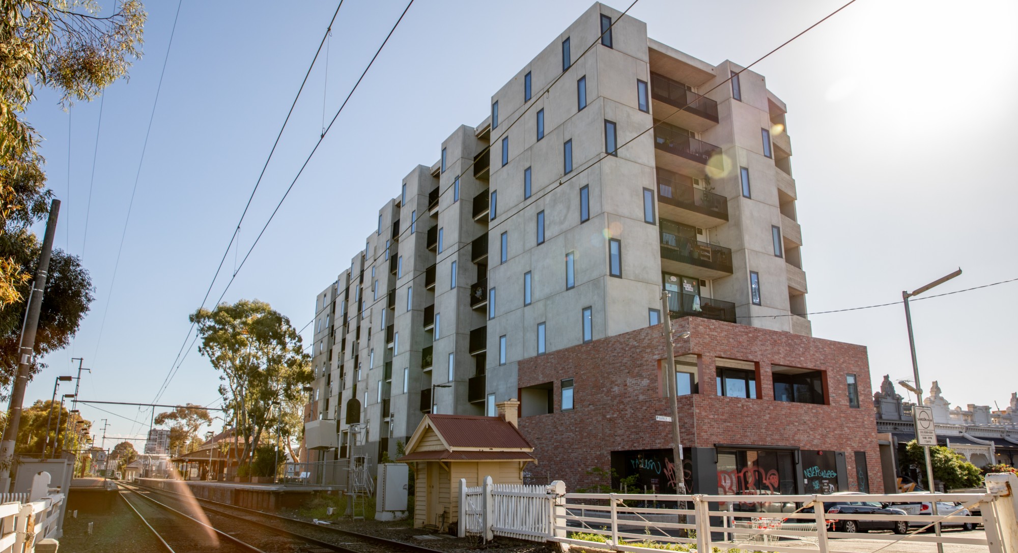 Nine-story apartment block alongside a railway crossing