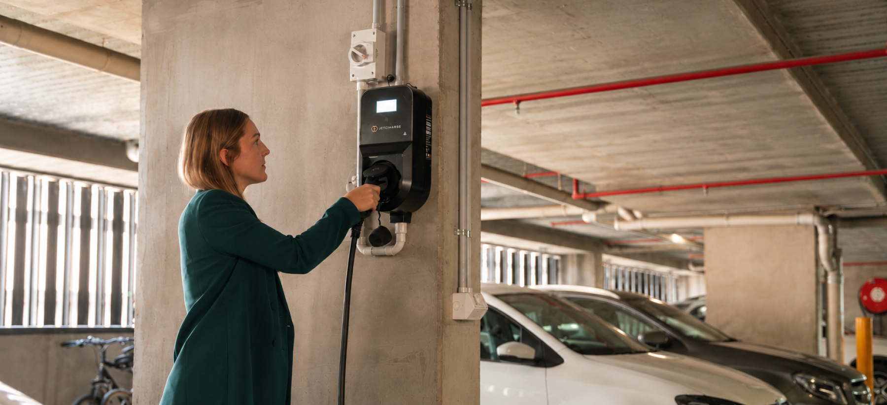 A person plugging their EV into a Level 2 charger